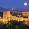 Spain, Andalusia, Granada Province, View of Alhambra Palace illuminated at night
