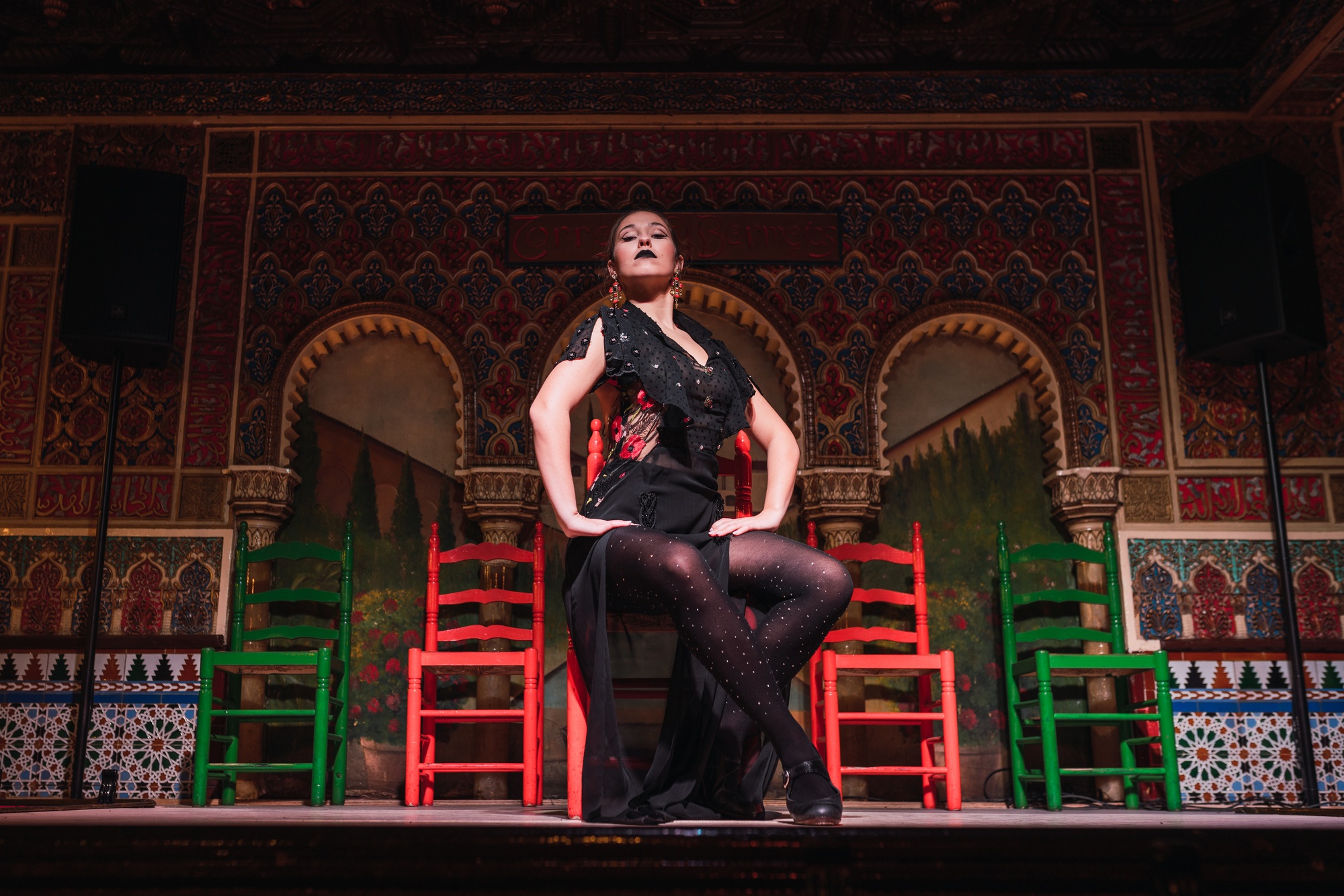Woman in dress dancing flamenco on scene