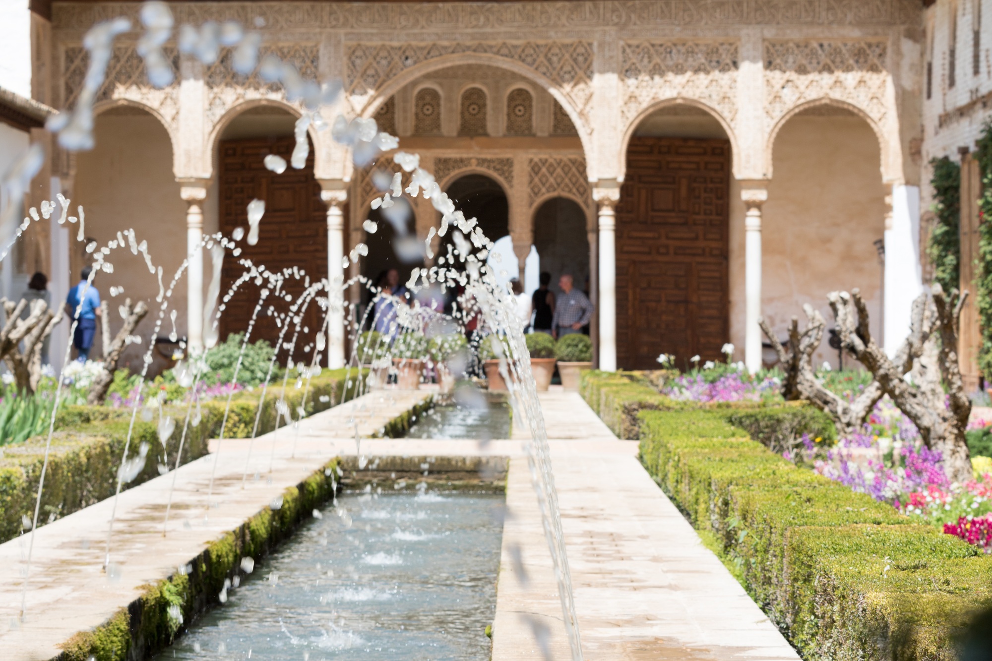 Granada, Spain - May 10, 2018: crowd of tourists near the fountain inside the city of the Alhambra