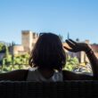 Detail of a girl in a terrace of a bar looking at the beautiful wire. Pomegranate