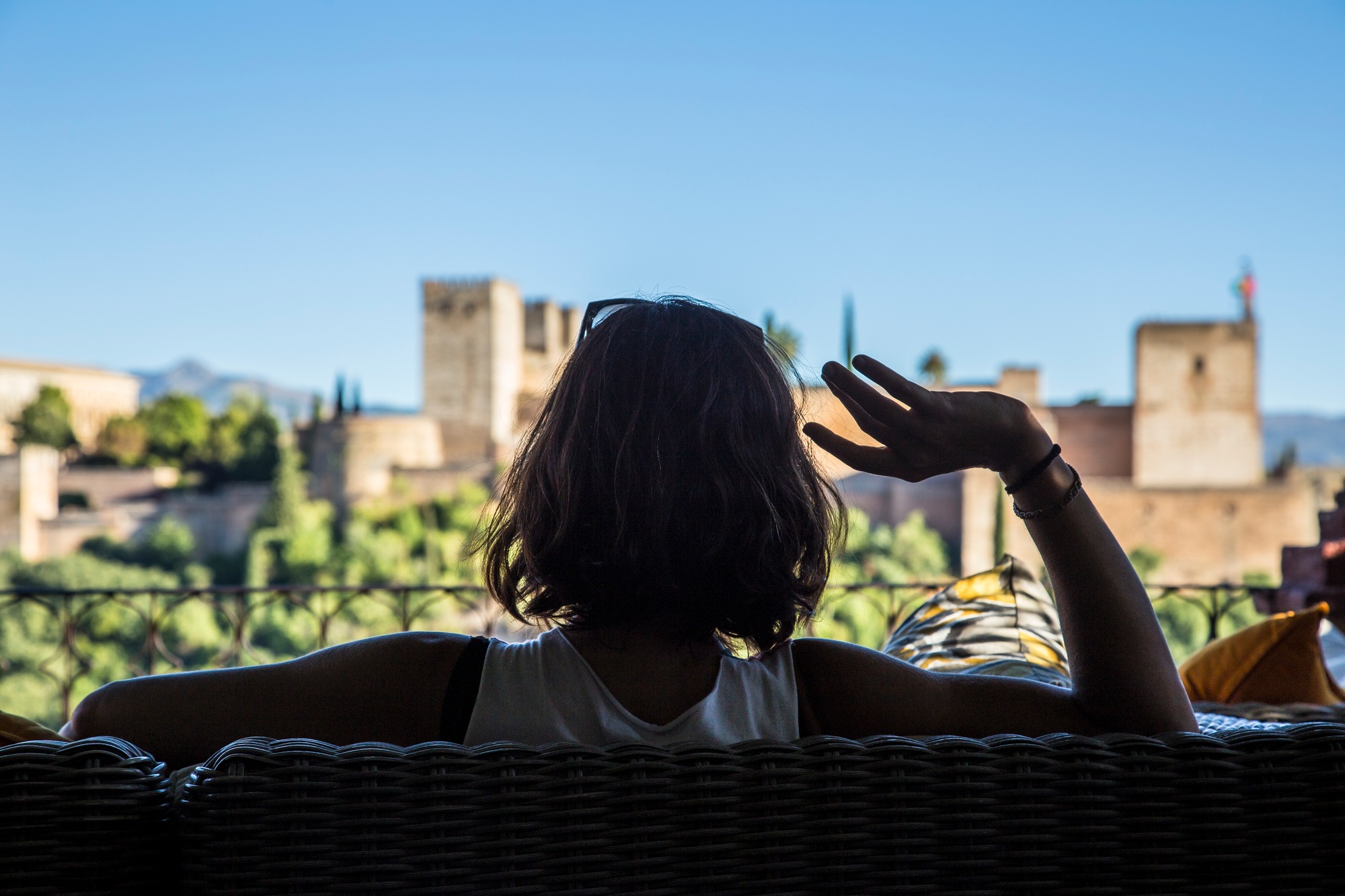 Detail of a girl in a terrace of a bar looking at the beautiful wire. Pomegranate