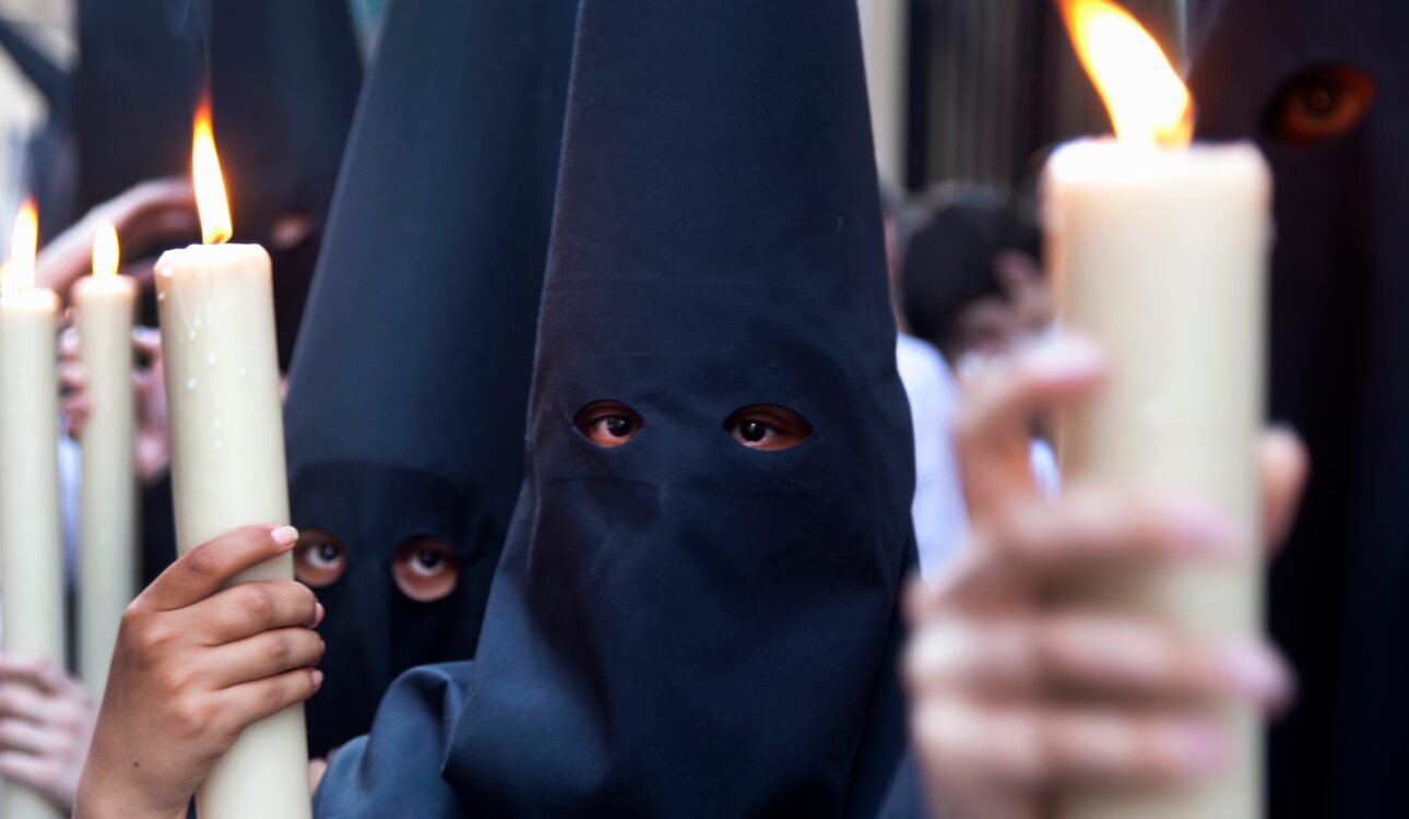 Children in robes with lit candles at a procession in Holy Week, Spain.