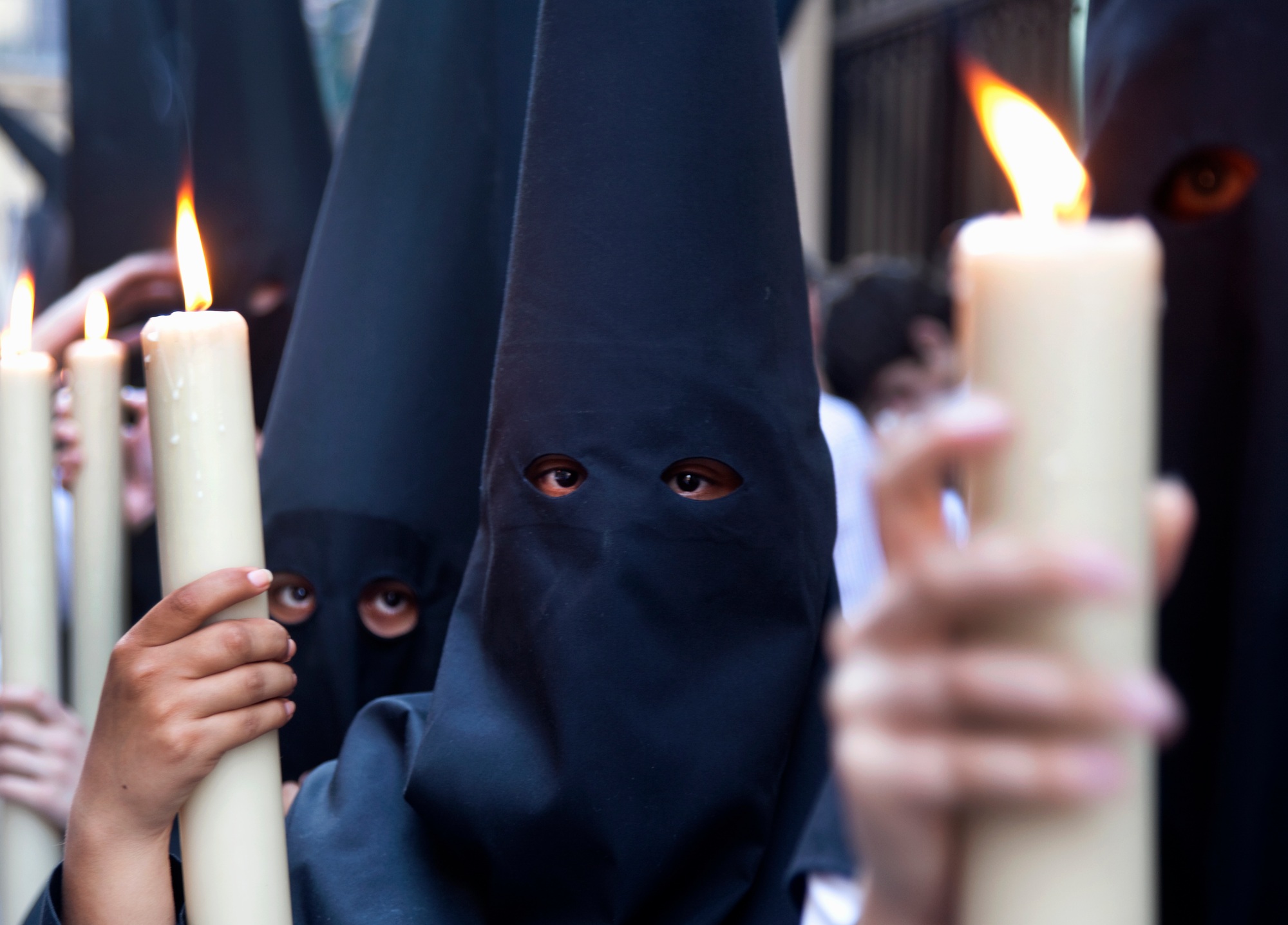 Children in robes with lit candles at a procession in Holy Week, Spain.