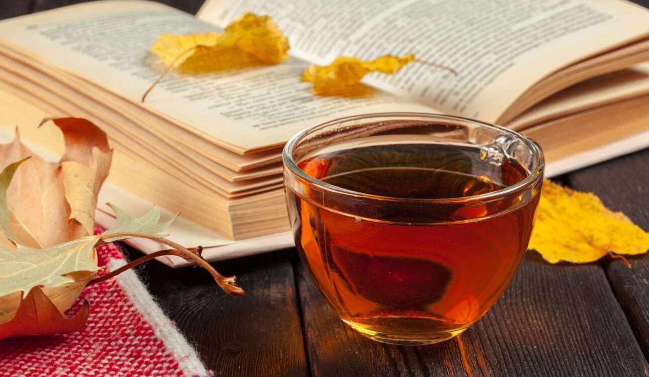Autumn leaves, book and cup of tea